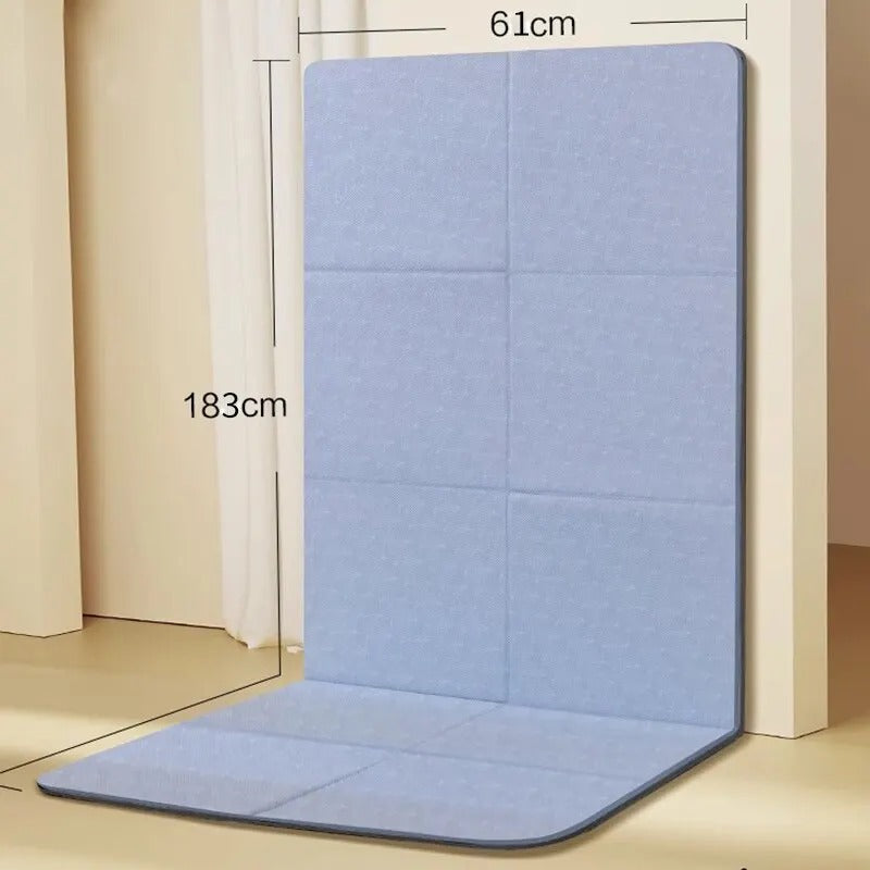 Foldable gym mat with dimensions detail. Folded against a wall.