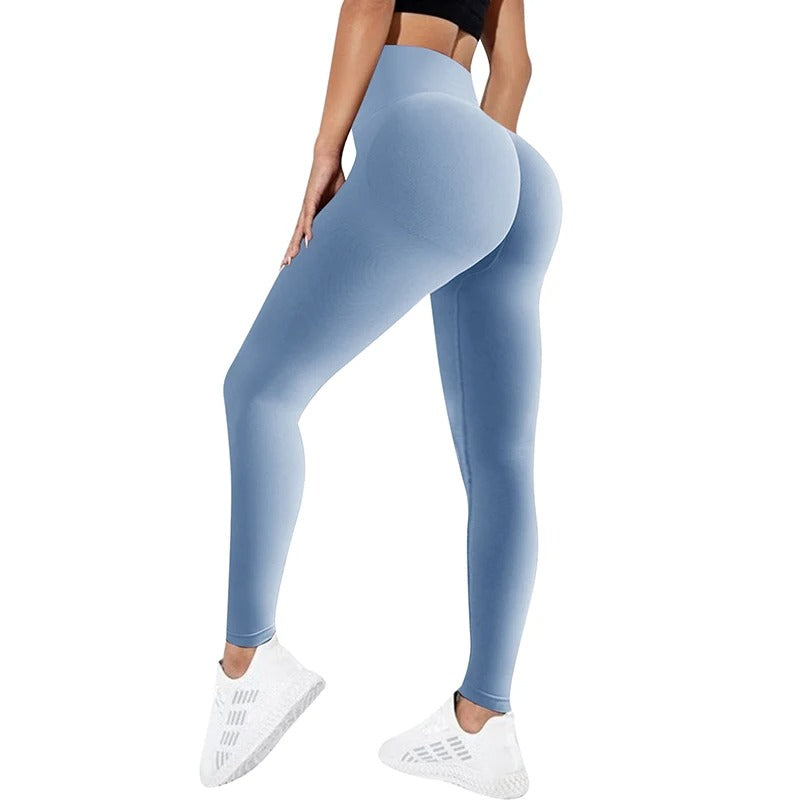 Woman wearing light blue yoga pants. View from behind.