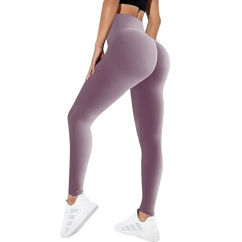 Woman wearing purple yoga pants. View from behind.