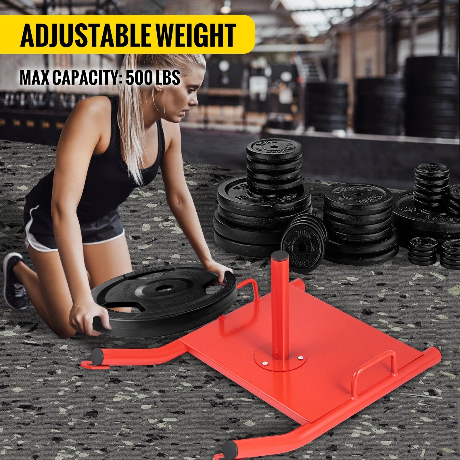 Woman adding weights to red heavy duty weight sled. 